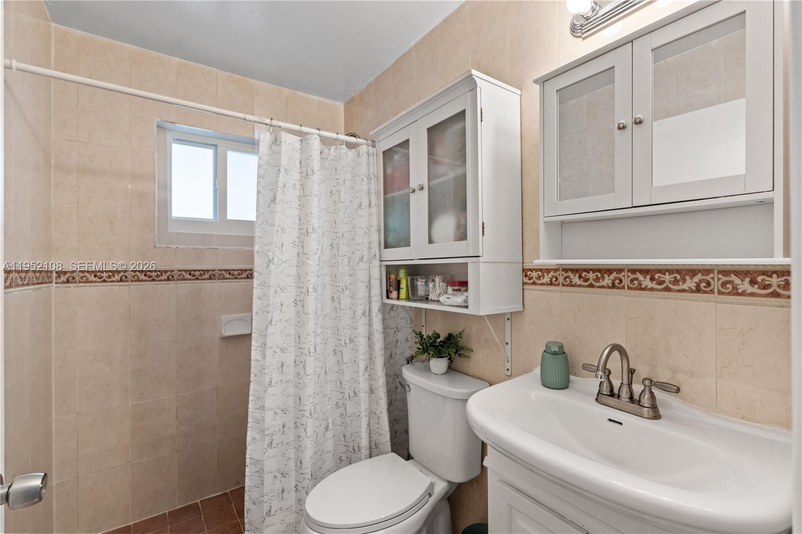 6919 West 29th Way Hialeah, FL 33018 - Photo 10 of 23 a bathroom with a sink toilet and shower