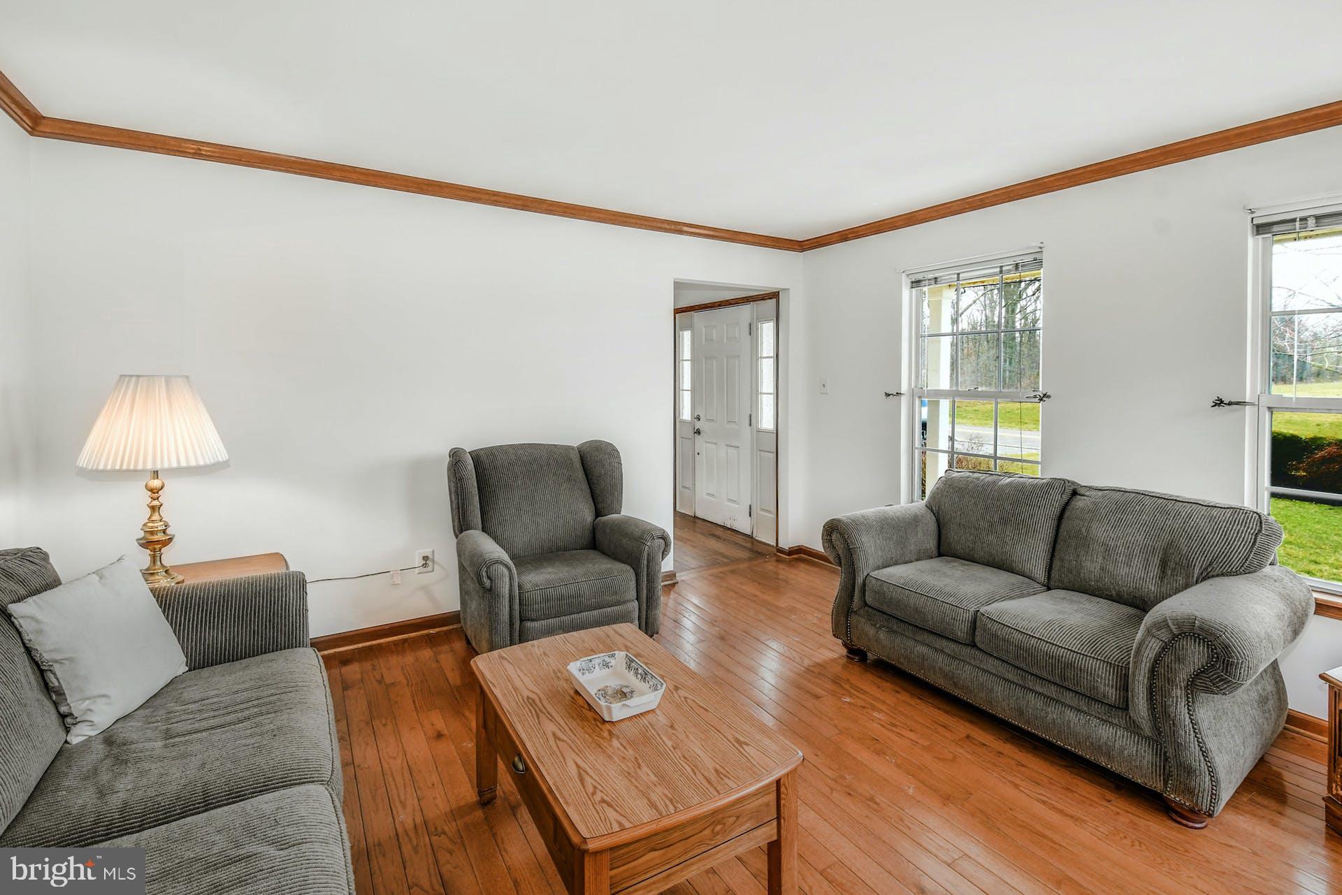 6013 German Road Pipersville, PA 18947 - Photo 4 of 30 Hardwood and Crown Enhance the Living Room