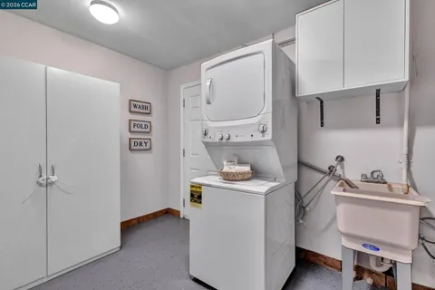 a room with a sink cabinets and utility