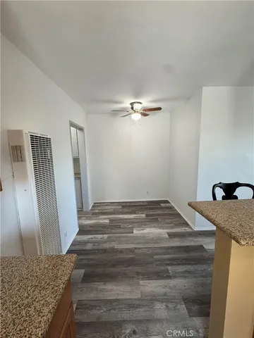a bathroom with a granite countertop sink and white cabinets