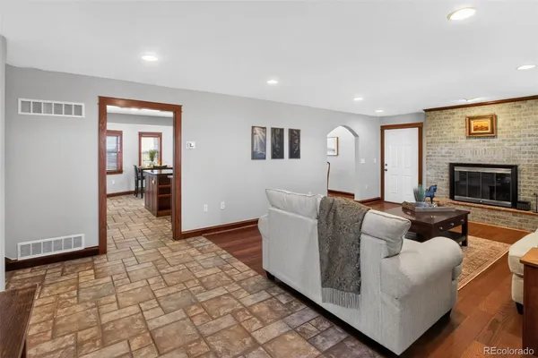 a living room with furniture and a fireplace