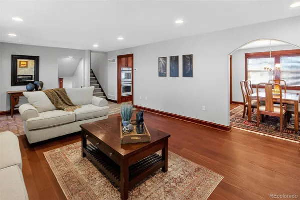 a living room with furniture and wooden floor