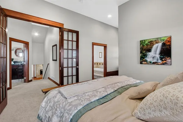 a bedroom with a large bed and a chandelier