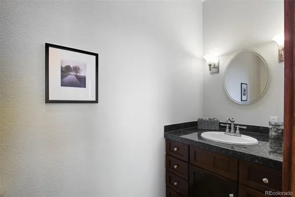 a bathroom with a sink vanity and a mirror