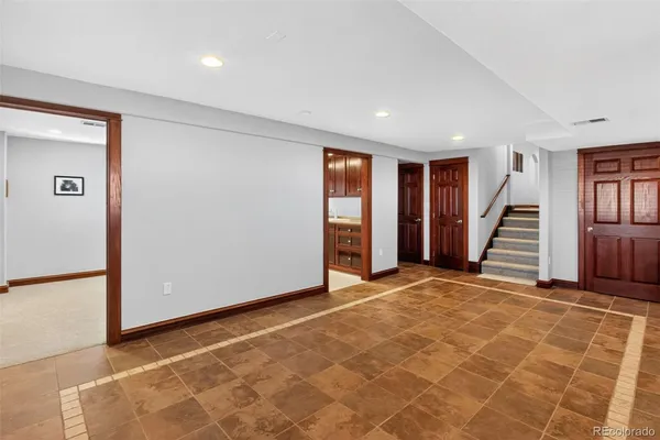a view of an empty room with stairs and a window