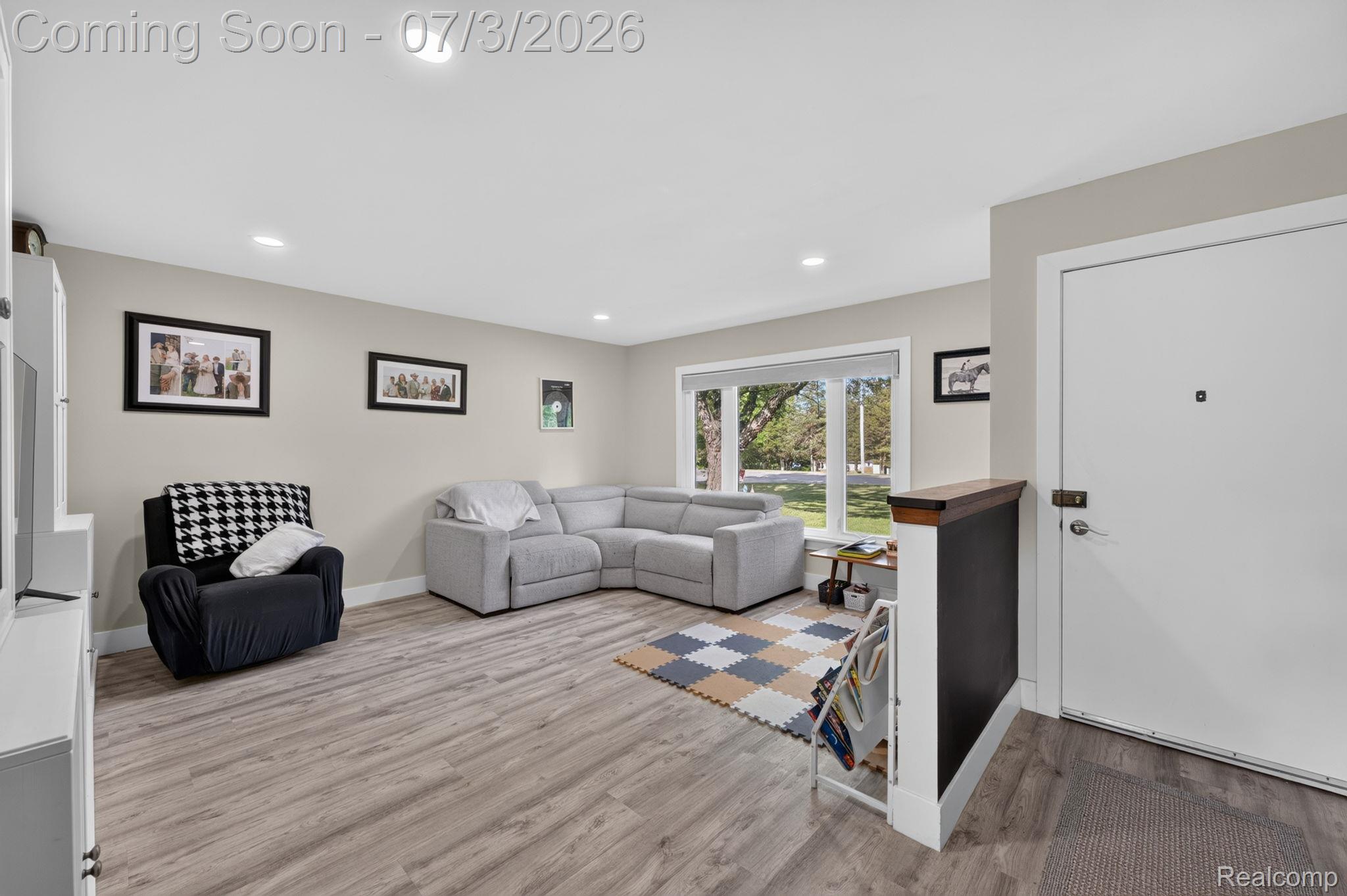 5355 North Seymour Road Flushing, MI 48433 - Photo 4 of 41 Spacious living area featuring light wood-finish flooring, a large picture window, recessed ceiling lighting, and neutral wall tones