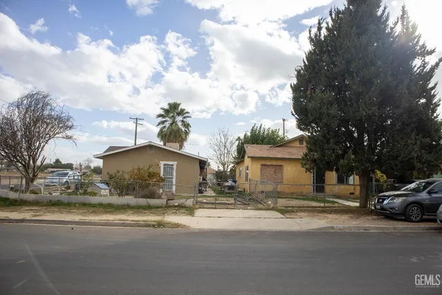 a couple of cars parked in front of a house