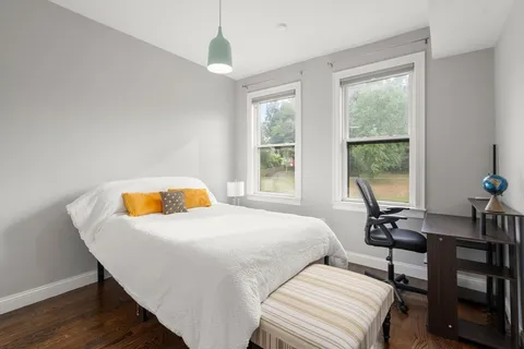 a bedroom with a bed and a window