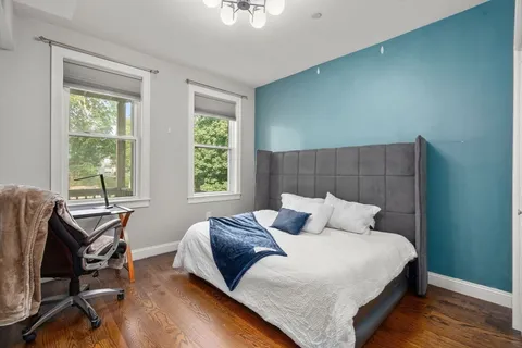 a bedroom with a bed a table and chair