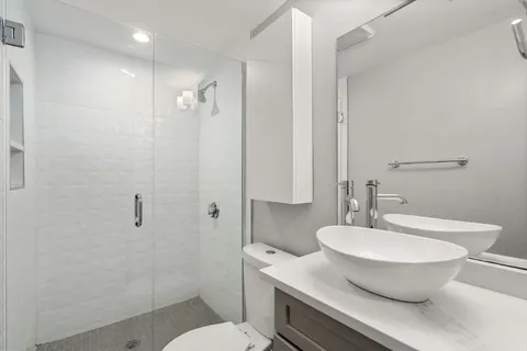 a bathroom with a toilet a sink and a mirror