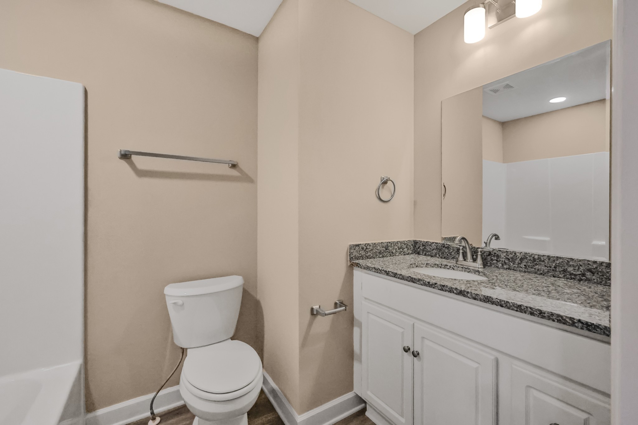 890 Blessing Way Gallatin, TN 37066 - Photo 16 of 19 a bathroom with a granite countertop toilet a sink and a mirror