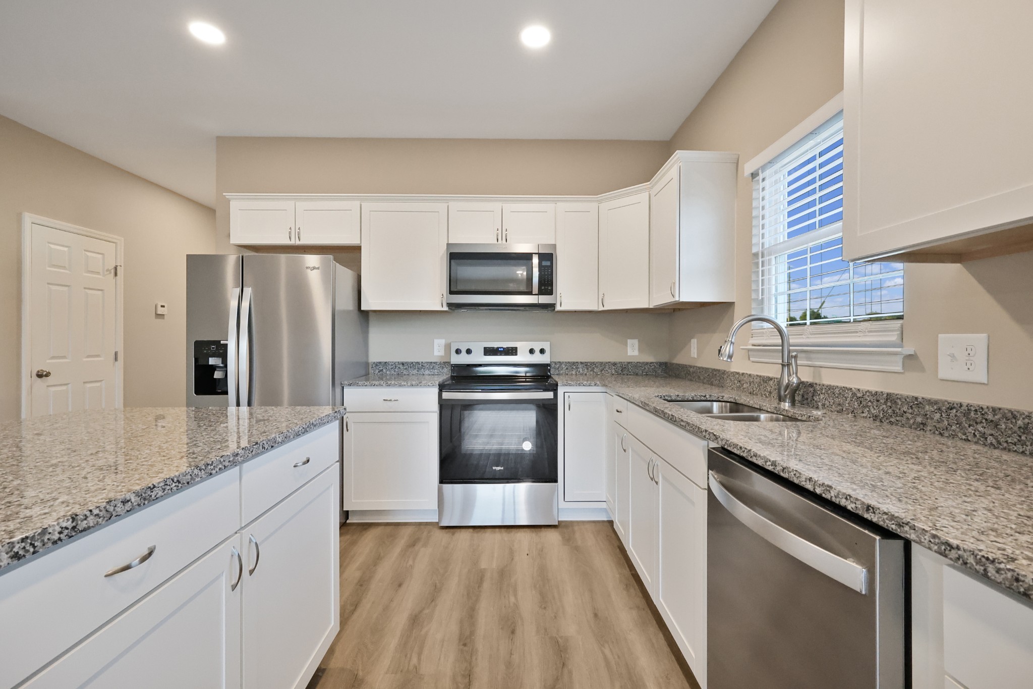 890 Blessing Way Gallatin, TN 37066 - Photo 4 of 19 a kitchen with granite countertop a refrigerator stove top oven and sink