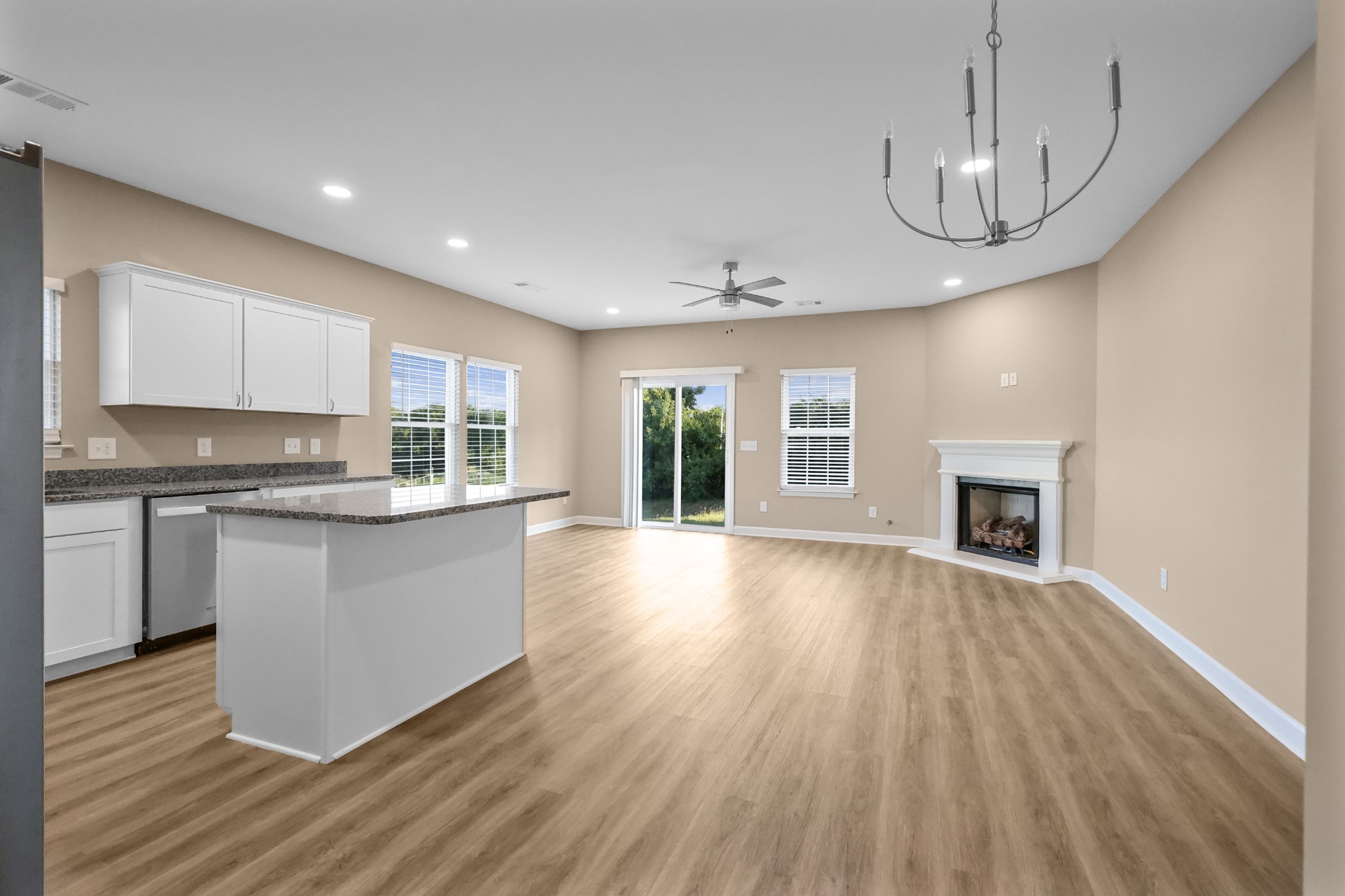 890 Blessing Way Gallatin, TN 37066 - Photo 5 of 19 a open kitchen with wooden floor and a fireplace