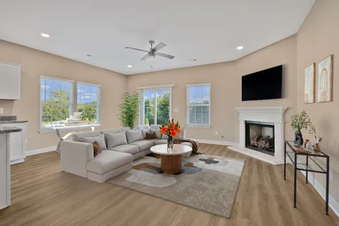 a living room with furniture a fireplace and a flat screen tv