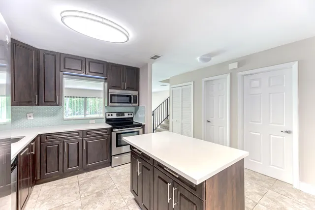 a kitchen with a stove a sink and a refrigerator