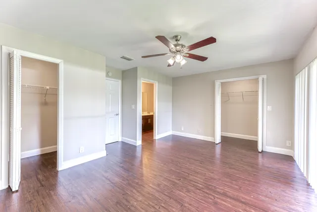 a view of an empty room with wooden floor