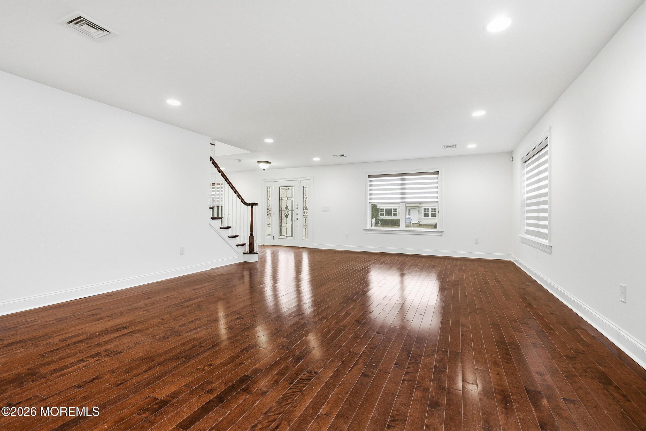 232 Woodcrest Road Oakhurst, NJ 07755 - Photo 17 of 49 a view of an empty room with wooden floor and a window