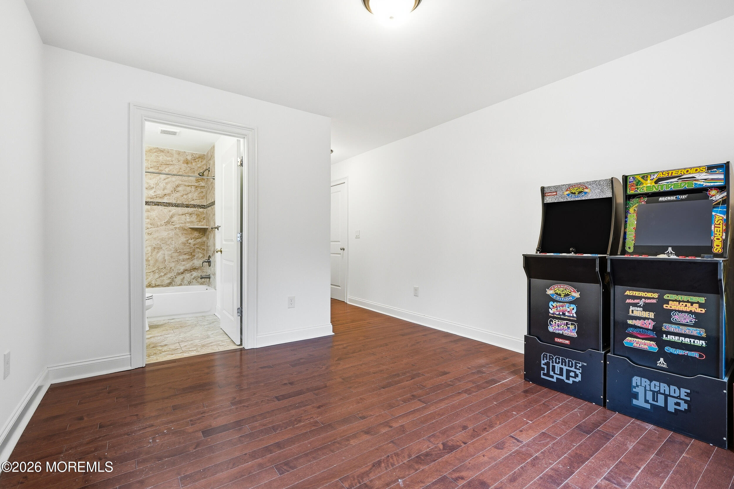 232 Woodcrest Road Oakhurst, NJ 07755 - Photo 22 of 49 a view of a room with wooden floor and bookshelf