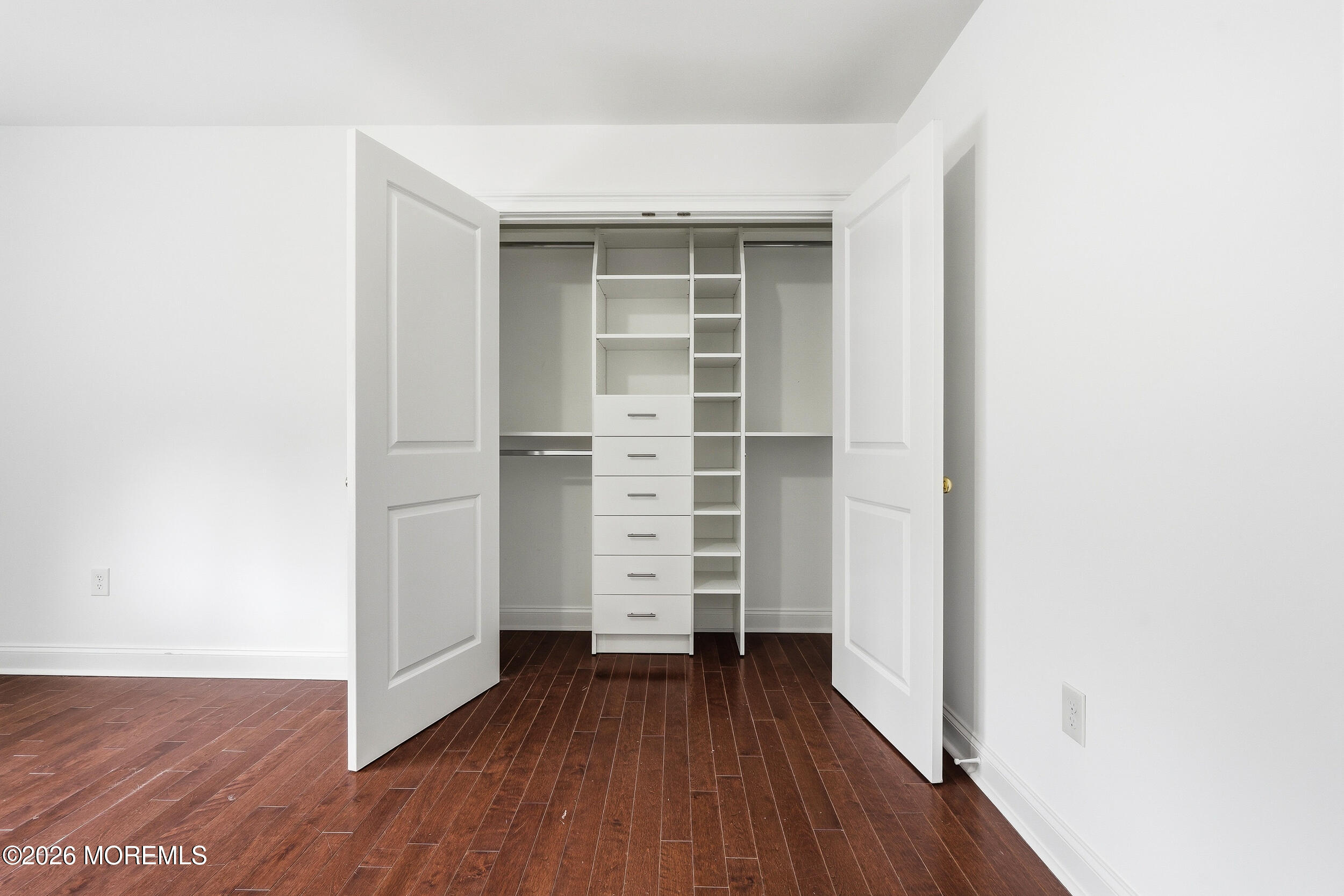 232 Woodcrest Road Oakhurst, NJ 07755 - Photo 28 of 49 a view of walk in closet with wooden floor