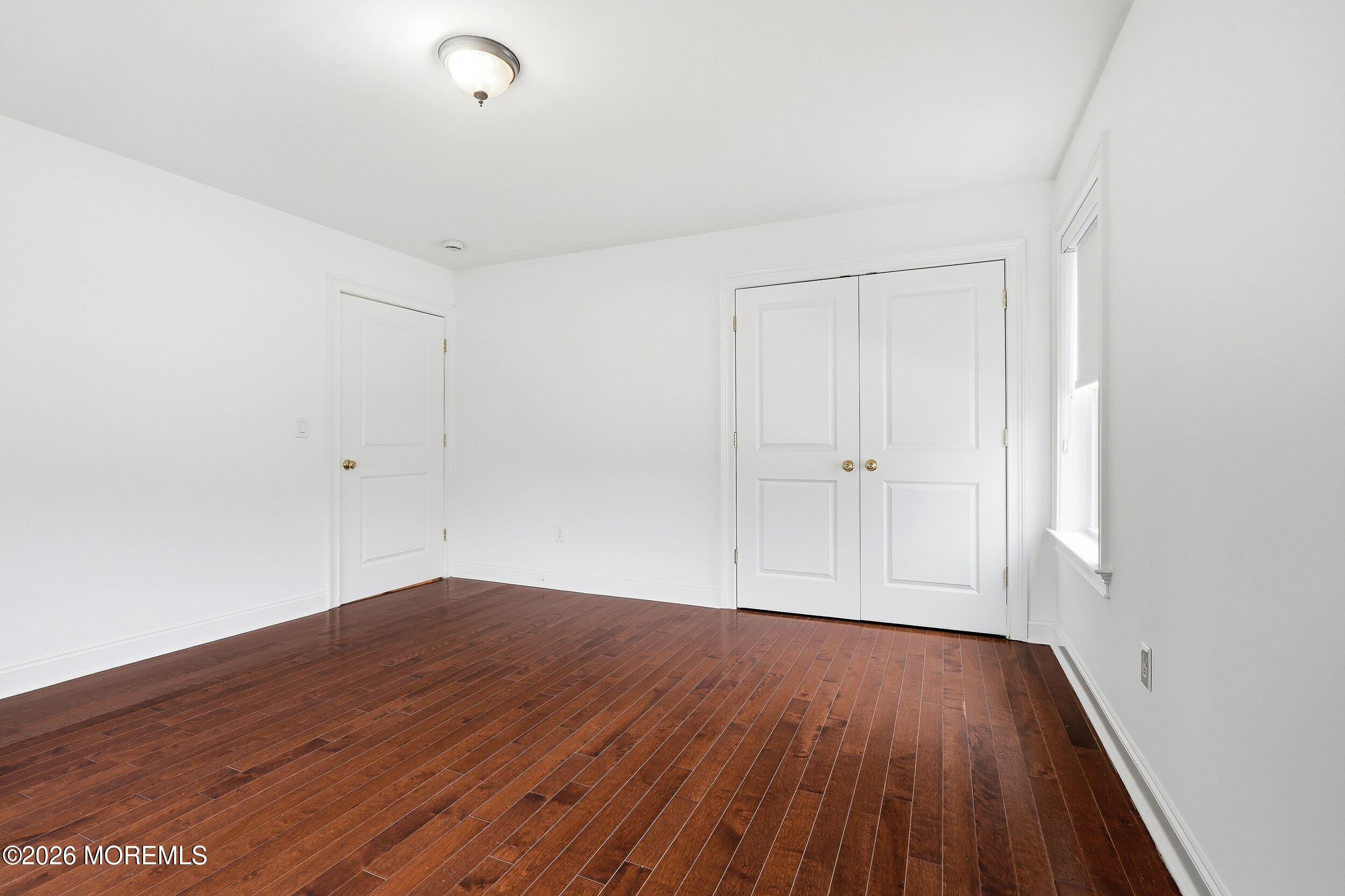 232 Woodcrest Road Oakhurst, NJ 07755 - Photo 29 of 49 an empty room with wooden floor