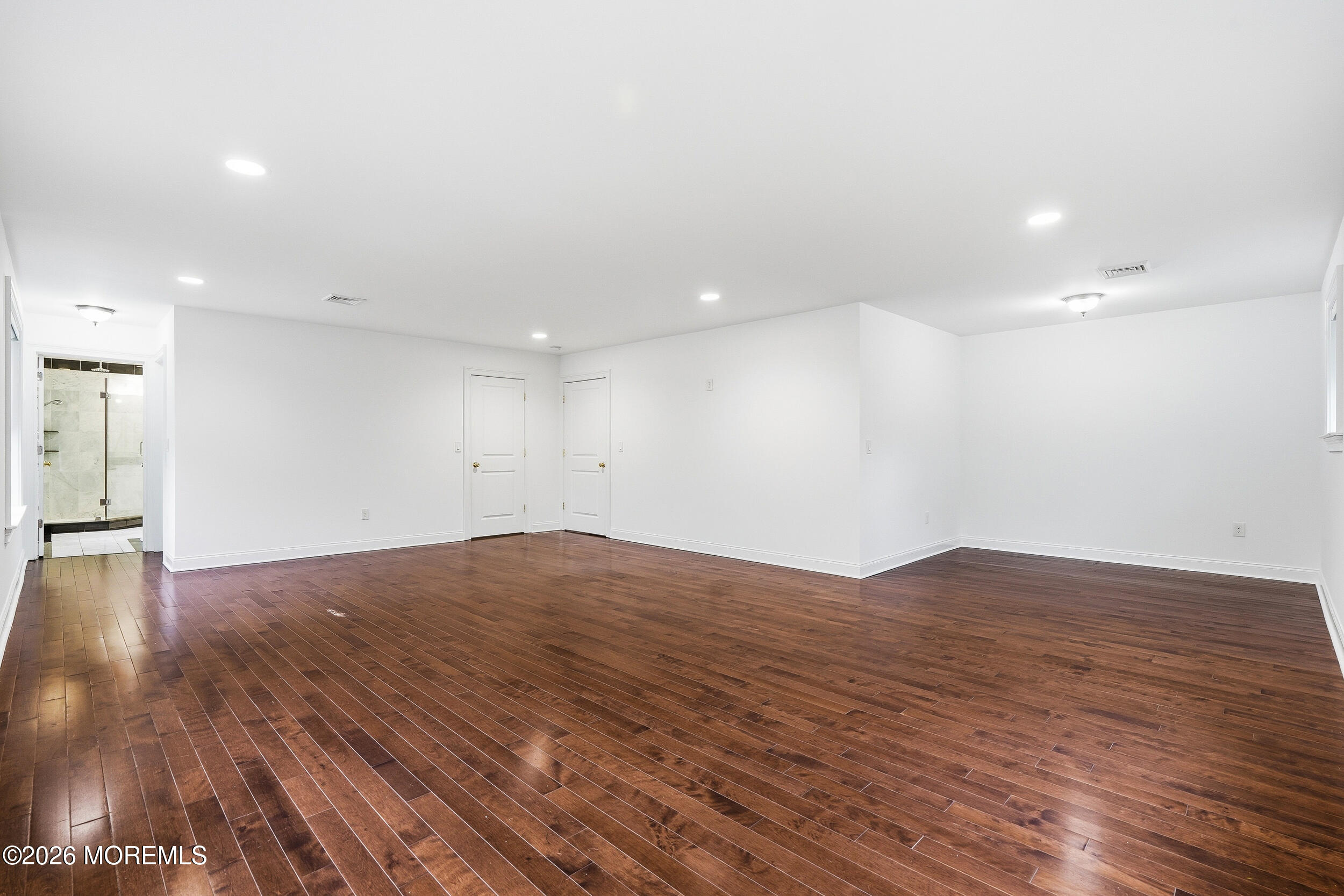 232 Woodcrest Road Oakhurst, NJ 07755 - Photo 39 of 49 a view of empty room with wooden floor and fan