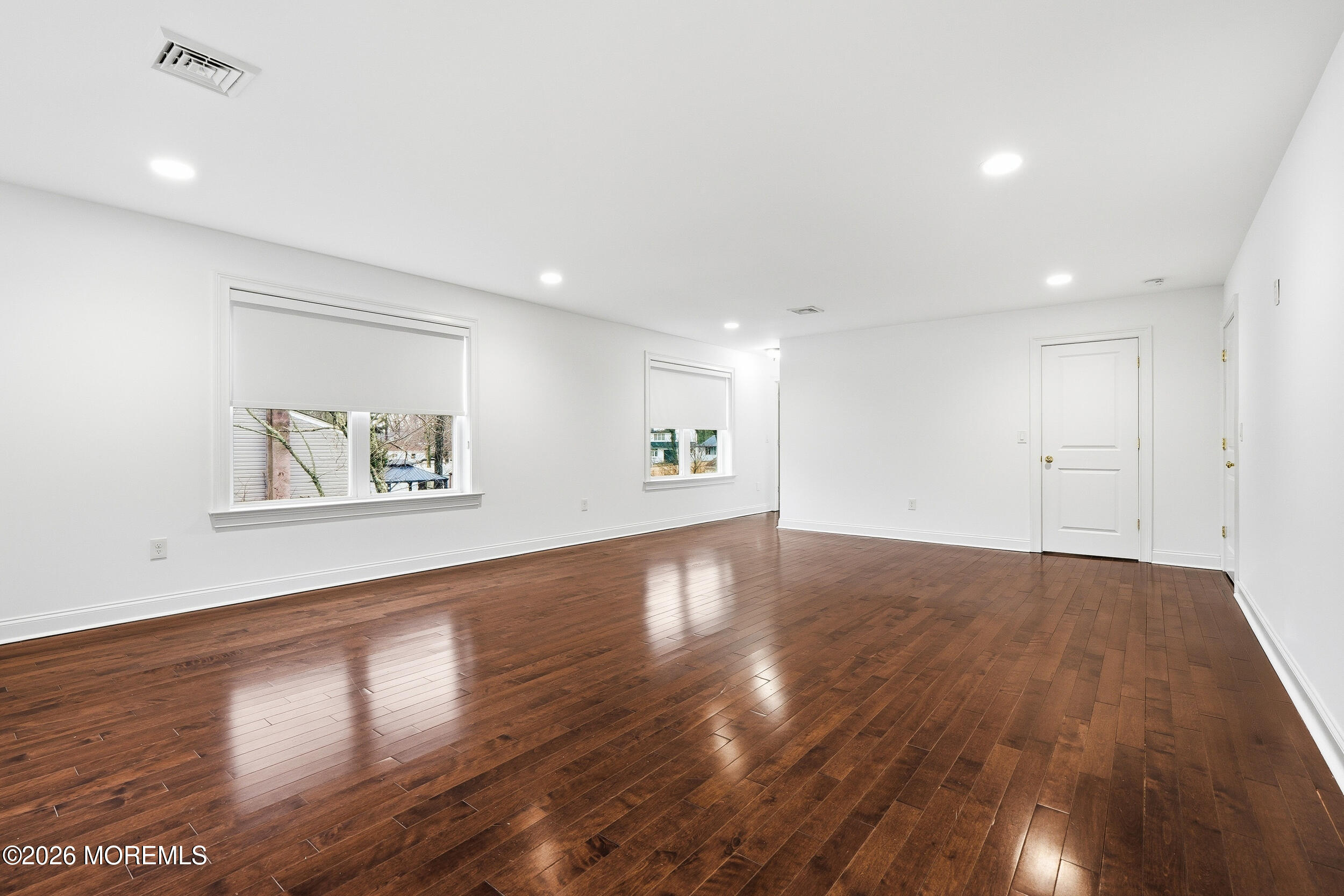 232 Woodcrest Road Oakhurst, NJ 07755 - Photo 40 of 49 a view of an empty room with wooden floor and a window