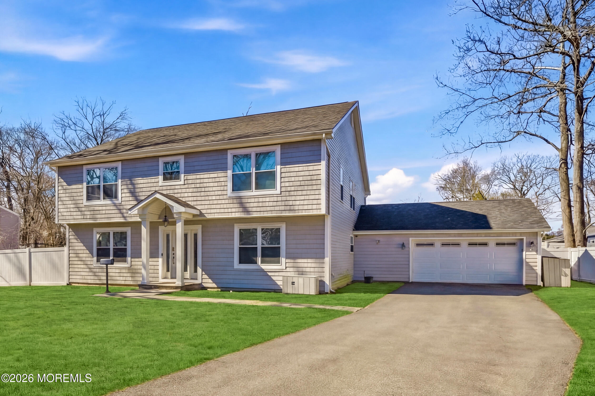 232 Woodcrest Road Oakhurst, NJ 07755 - Photo 9 of 49 a front view of a house with a garden and yard