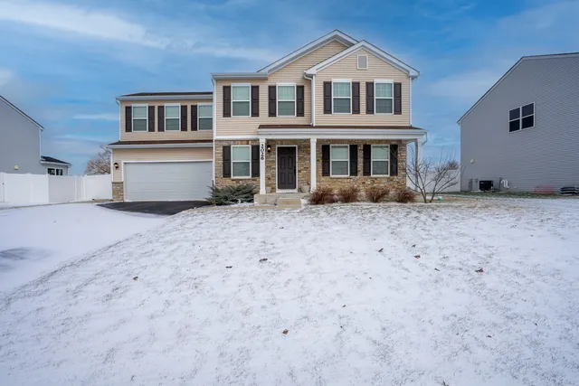 a view of house with backyard and sitting area