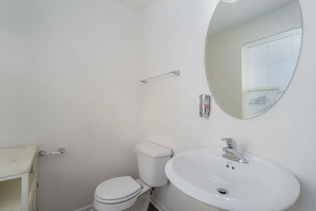 a white toilet sitting next to a bathroom sink