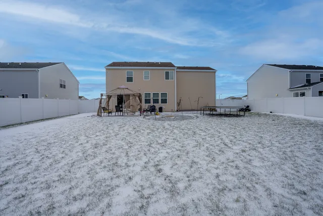 a view of a dry yard with wooden fence