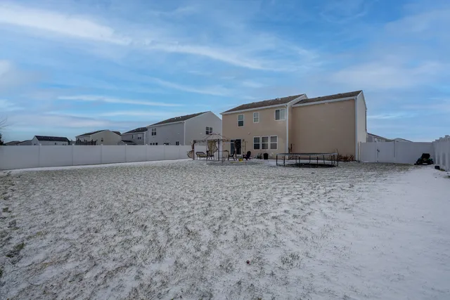 a view of a house with a backyard