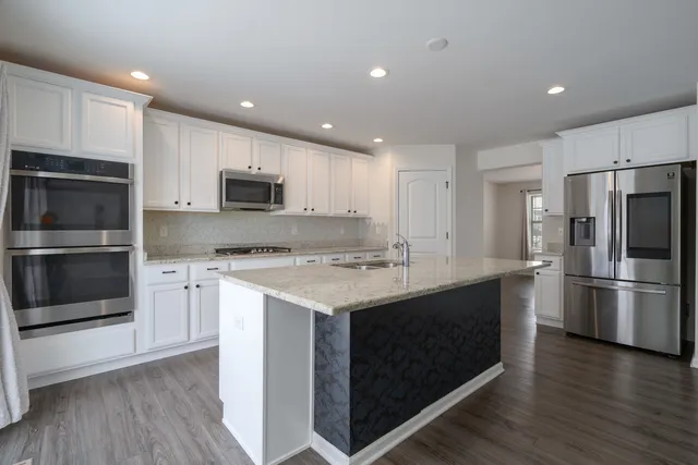 a kitchen with a refrigerator stove and microwave