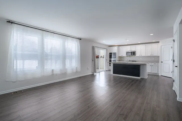 a view of a kitchen with a stove cabinets and wooden floor