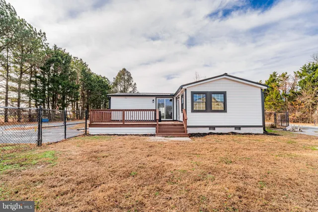 a white house that has a tree in front of it
