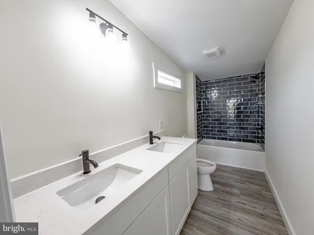 a bathroom with a bathtub sink vanity mirror and shower