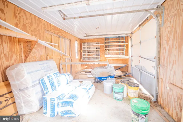 a dining room with furniture and a large window