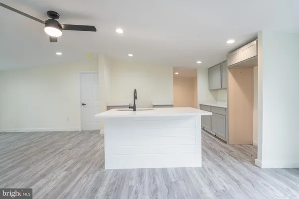 a view of kitchen with stainless steel appliances kitchen island a sink and a refrigerator
