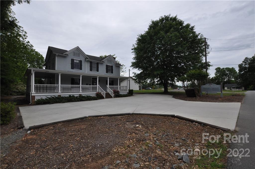 5 Oak Grove Street, Unit 4 Mount Holly, NC 28120 - Photo 2 of 10 a front view of a house with a yard