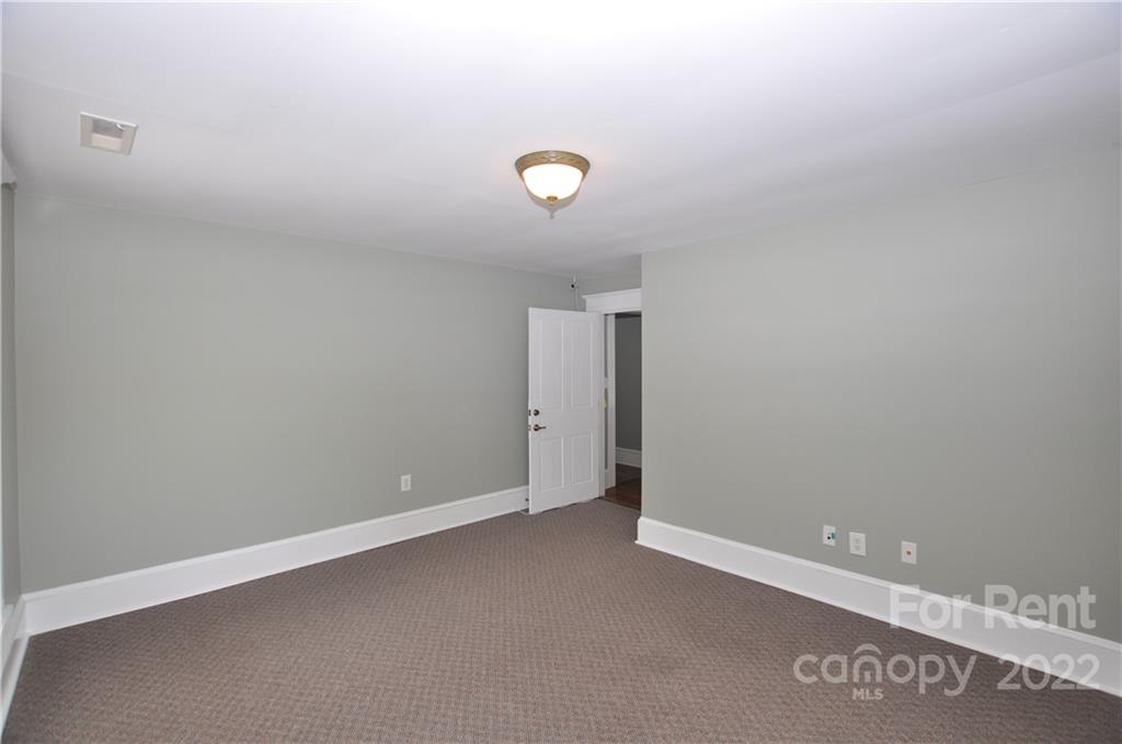 5 Oak Grove Street, Unit 4 Mount Holly, NC 28120 - Photo 6 of 10 an empty room with a fan