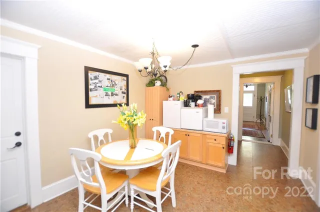 a dining room with furniture and chandelier