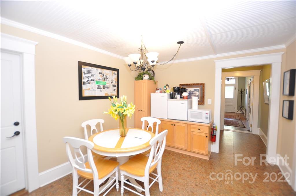 5 Oak Grove Street, Unit 4 Mount Holly, NC 28120 - Photo 9 of 10 a dining room with furniture and chandelier