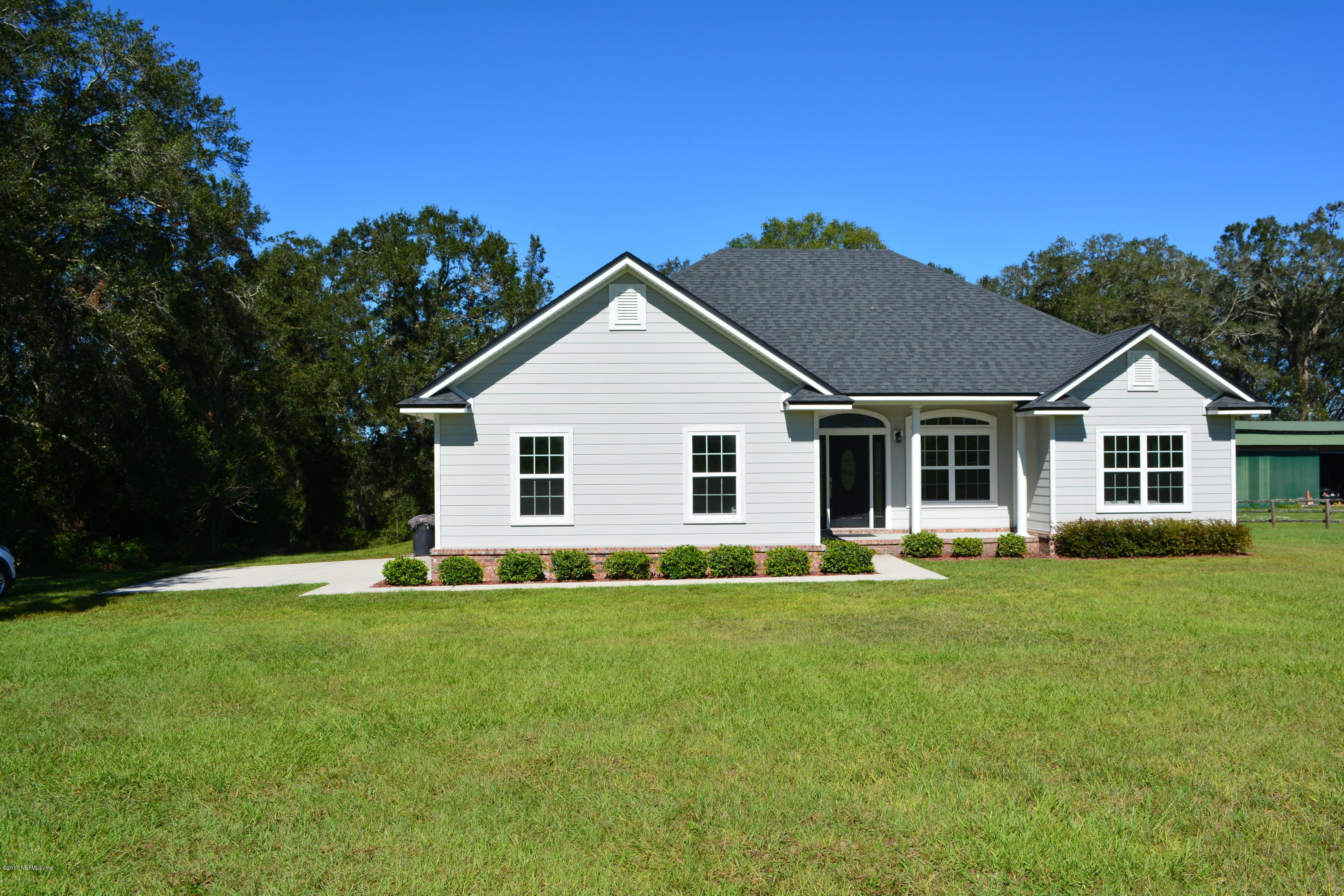 5345 Eva Jones Road Macclenny, FL 32063 - Photo 1 of 22 a front view of a house with a garden