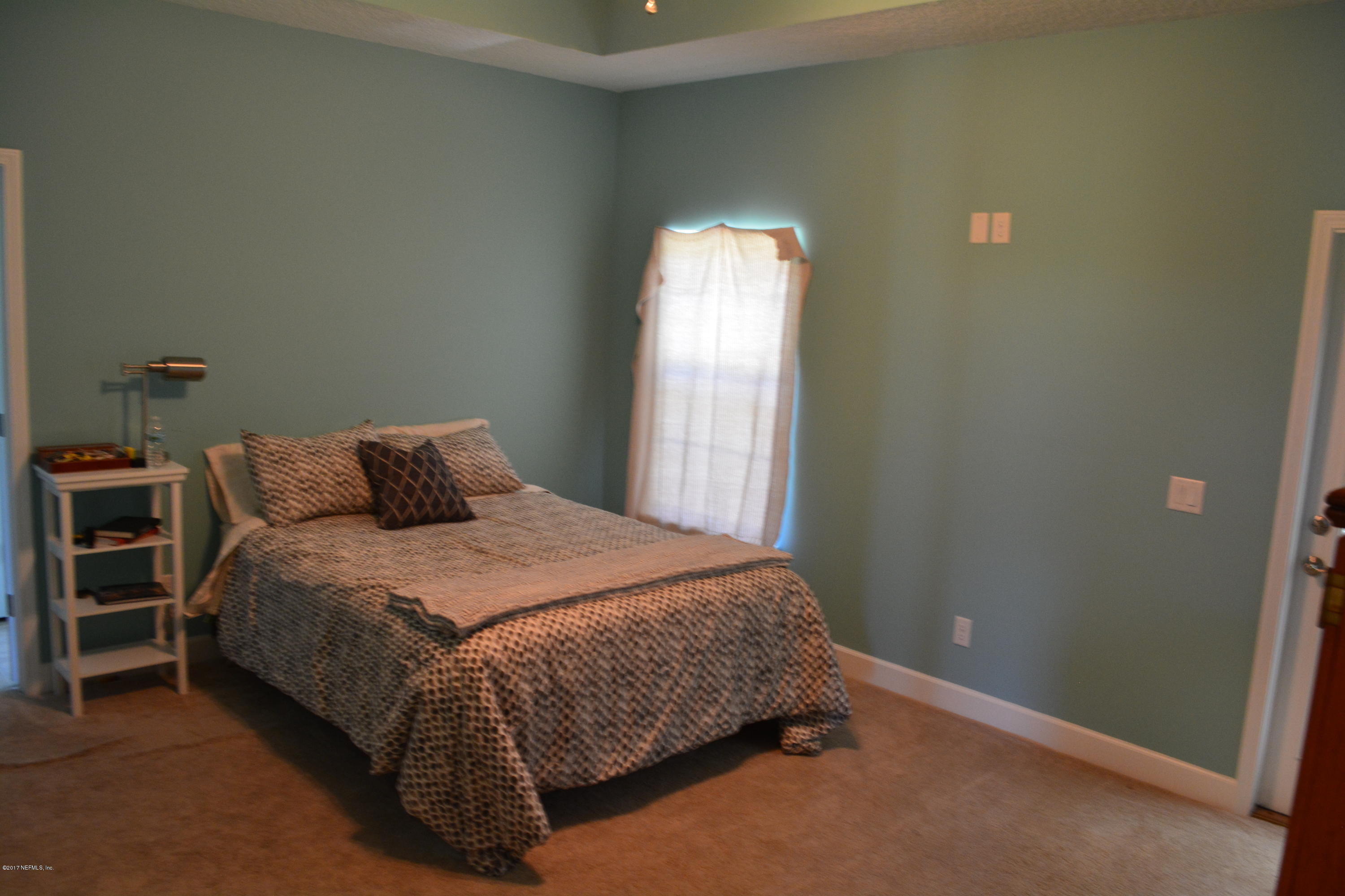 5345 Eva Jones Road Macclenny, FL 32063 - Photo 11 of 22 a bedroom with a bed and a window