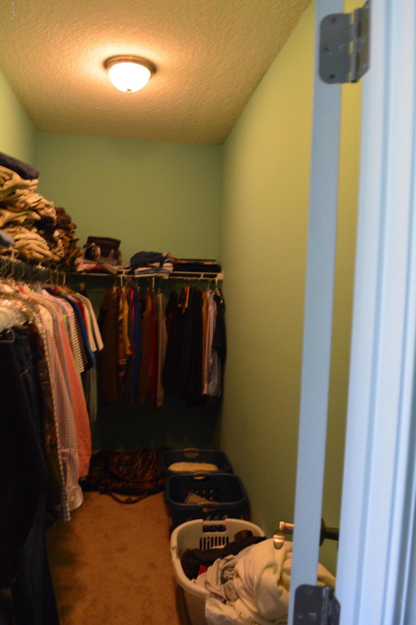 5345 Eva Jones Road Macclenny, FL 32063 - Photo 15 of 22 a view of walk in closet with clothes and shoes