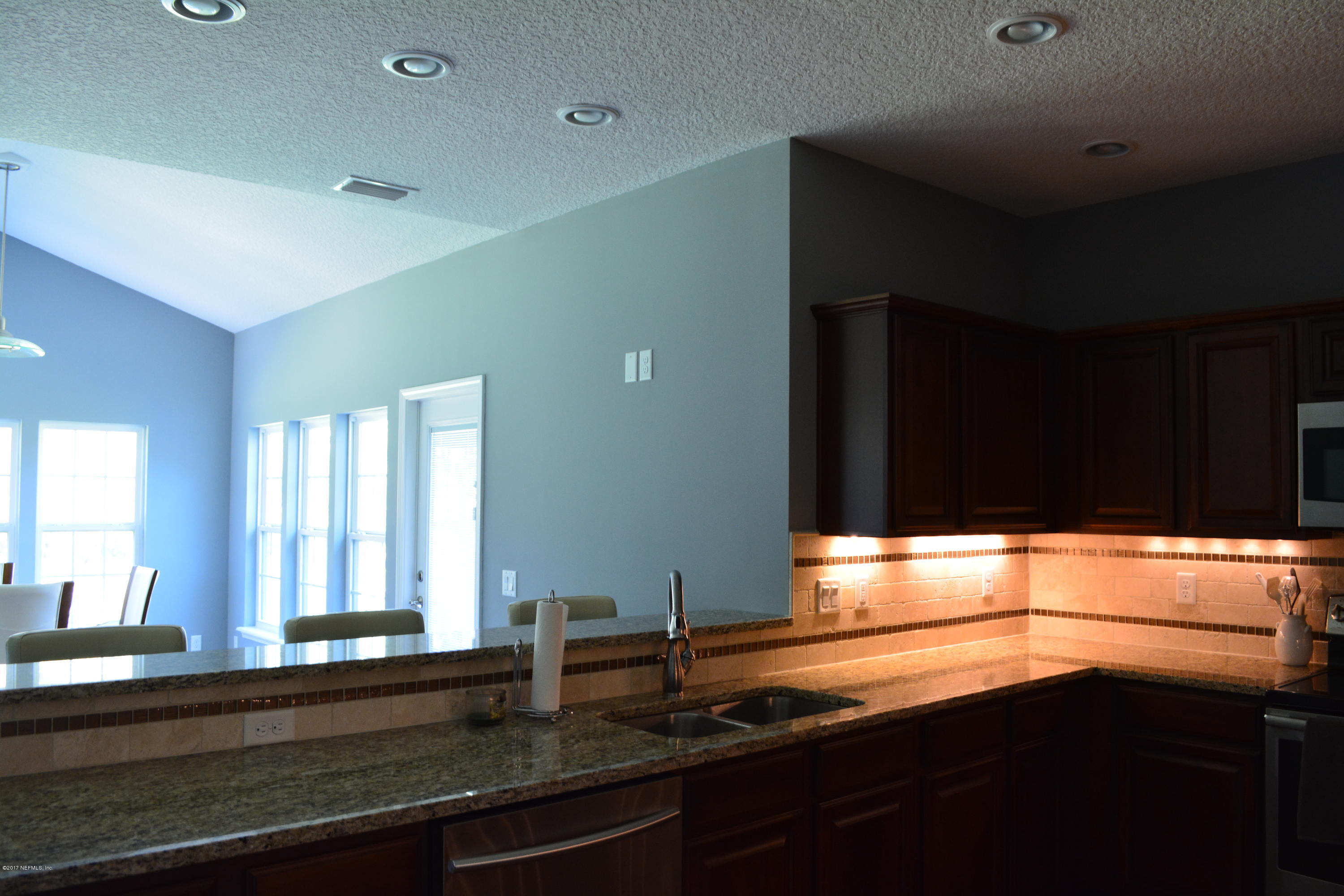 5345 Eva Jones Road Macclenny, FL 32063 - Photo 9 of 22 a kitchen with granite countertop white cabinets and a window