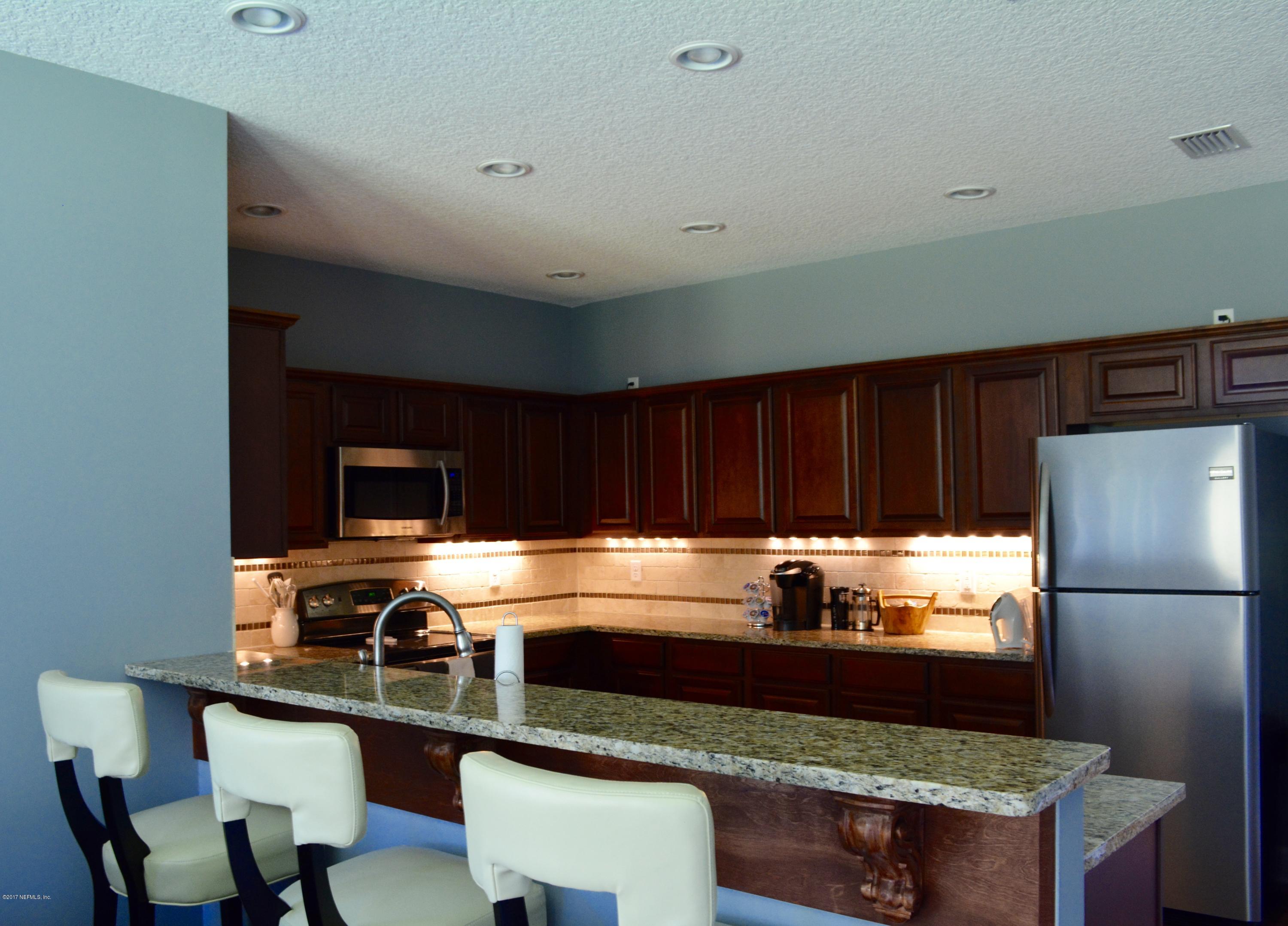 5345 Eva Jones Road Macclenny, FL 32063 - Photo 10 of 22 a kitchen with stainless steel appliances a stove a sink and a refrigerator