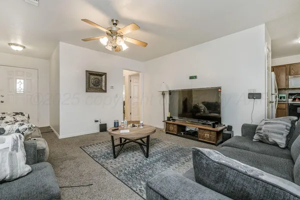 a living room with furniture and a flat screen tv