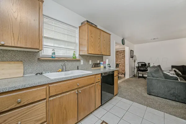 a kitchen with a sink stove and cabinets