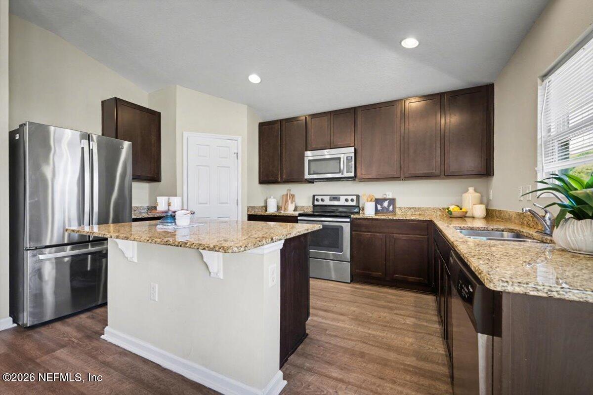 7401 Steventon Way Jacksonville, FL 32244 - Photo 12 of 32 a kitchen with stainless steel appliances granite countertop a sink stove and refrigerator