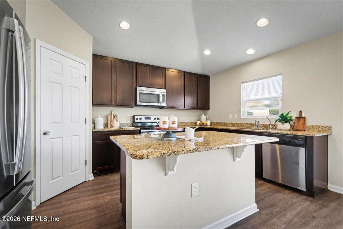 7401 Steventon Way Jacksonville, FL 32244 - Photo 14 of 32 a kitchen with stainless steel appliances granite countertop a sink stove and refrigerator